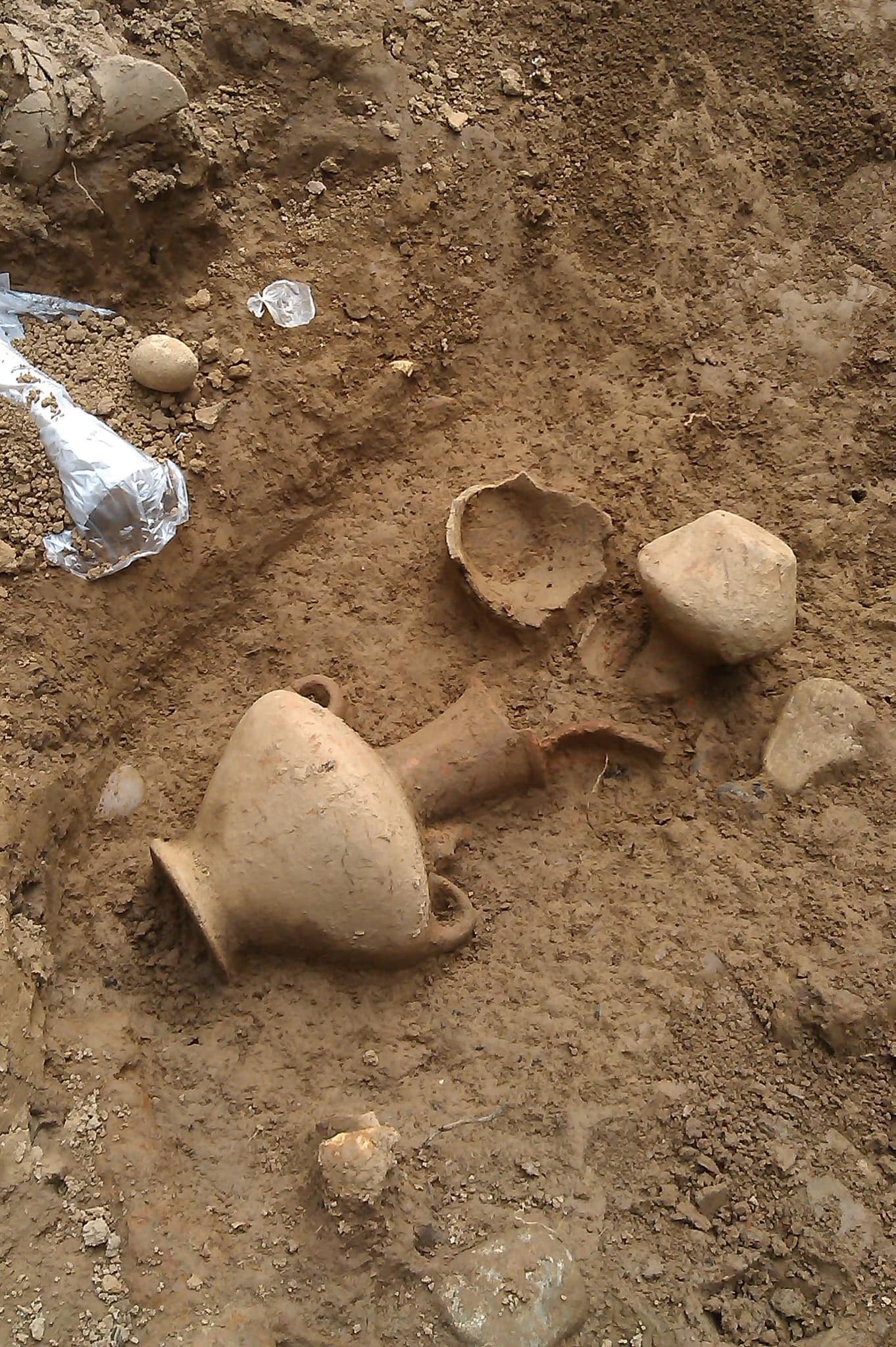 Two Handled vessel made of clay, the upper half of the body is covered with net ornaments filled with chevron patterns